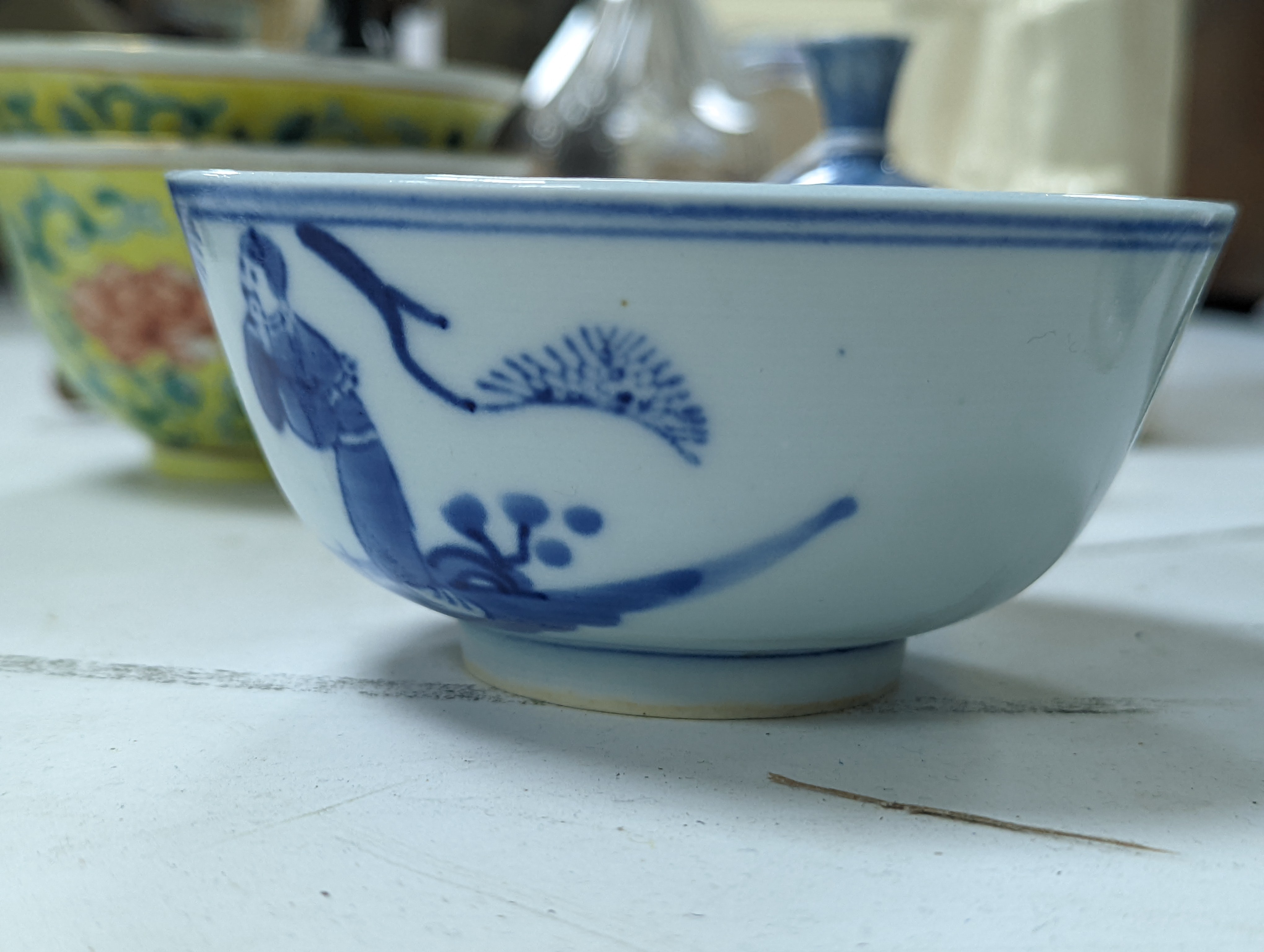 A group of Chinese porcelain, 19th /20th century, to include a pair of yellow ground bowls, 10.8 cm diameter, a blue and white vase, Xuande mark, a similar bowl and vase, and a champleve enamel bronze koro and cover